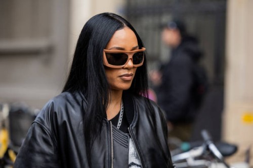 Aleali May wears black leather jacket, shirt with print outside 032C during the Menswear Fall Winter 2025/2026 as part of Paris Fashion Week on...