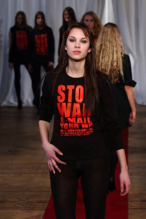 Alexa Chung wears a creation by designer Katharine Hamnett during her autumn/winter 2003 collection catwalk show as part of London Fashion Week at...