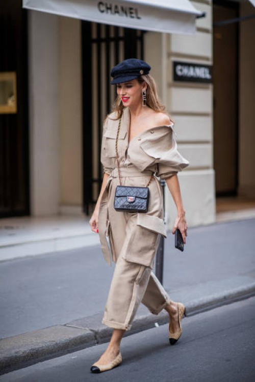 Alexandra Lapp is seen wearing a beige Frankie Shop jumpsuit, Chanel earrings, vintage Chanel classic bag, Chanel ballerinas, Chanel baker boy cap...