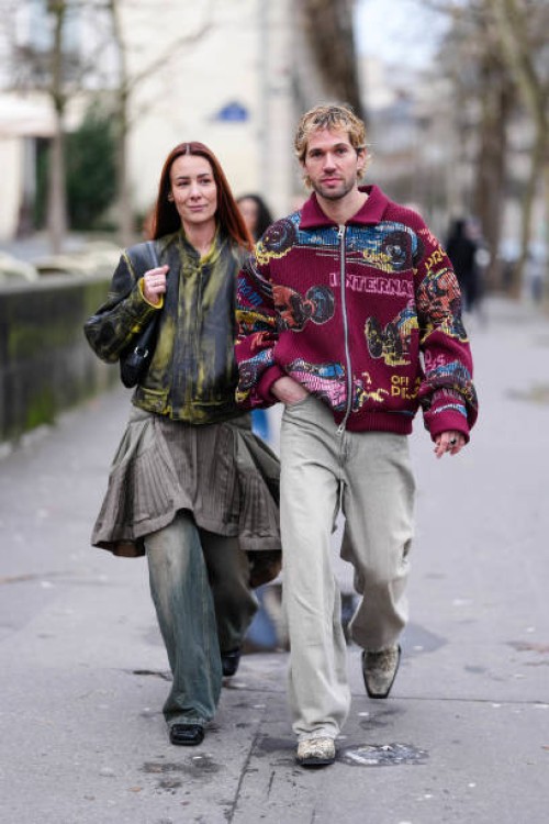Alice Barbier wears dark green light green pattern leather jacket, dark gray over the knee skirt, black leather bag, dark gray washed slouchy denim...