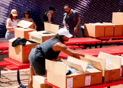 Alicia Fairchild, bottom, helps unbox and unload Beyoncé merchandise before the artists two weekend concerts at NRG Stadium, Saturday, Sept. 23 in...