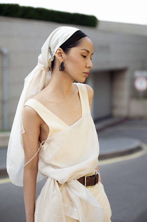Amalik Baiganisheva wears beige wide pants, brown belt, beige top, beige head scarf during day 1 of Visa Fashion Week Almaty 2025 on May 03, 2025 in...