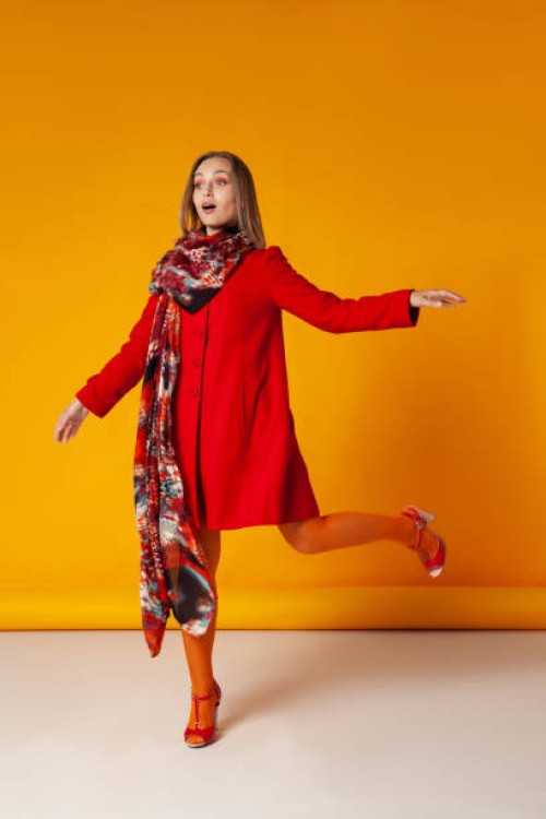 amazed woman in stylish outerwear walking in studio - fashion stock pictures, royalty-free photos & images
