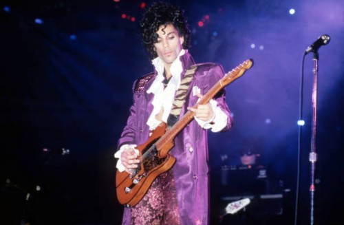 American singer, songwriter, musician, record producer, dancer, actor, and filmmaker Prince performs onstage during the 1984 Purple Rain Tour on...