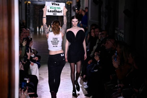 An activist of People for the Ethical Treatment of Animals takes to the catwalk to protest against the use of leather in the fashion industry, as...