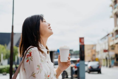 an asian chinese woman enjoying coffee on the go - junk food stock pictures, royalty-free photos & images
