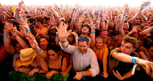 an ecstatic crowd of cheering fans at music festival - concert stock pictures, royalty-free photos & images