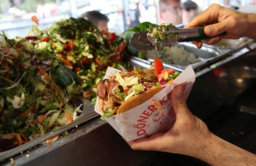 An employee prepares a customer's order at Mustafas Gemüse Kebap on July 06, 2022 in Berlin, Germany. The döner kebab, a fast food sandwich made of...