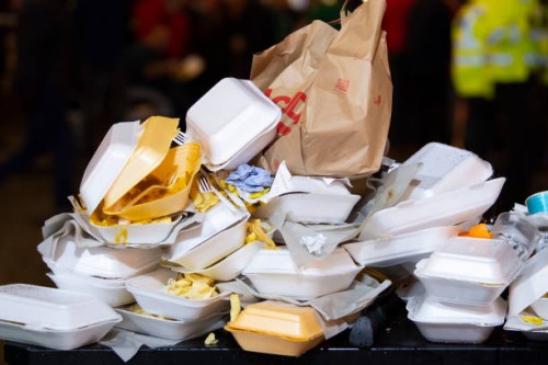 An overflowing bin full of takeaway food containers at night on March 16, 2019 in Cardiff, United Kingdom.