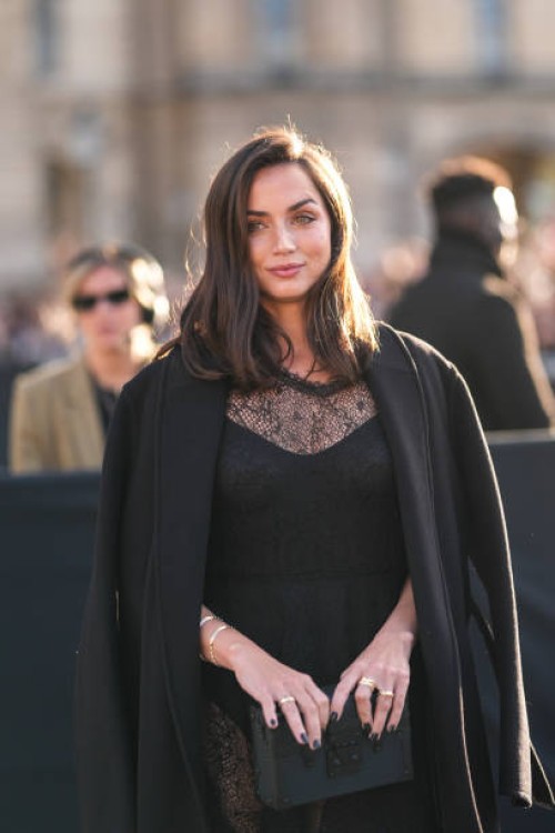 Ana de Armas wears a black coat, a black dress in transparent lace, outside Louis Vuitton, during the Paris Fashion Week Spring/Summer 2025 on...
