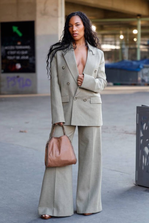 Angel Arutura wears light green suit, brown Stella McCartney bag, outside Stella McCartney, during the Womenswear Fall/Winter 2025/2026 as part of...