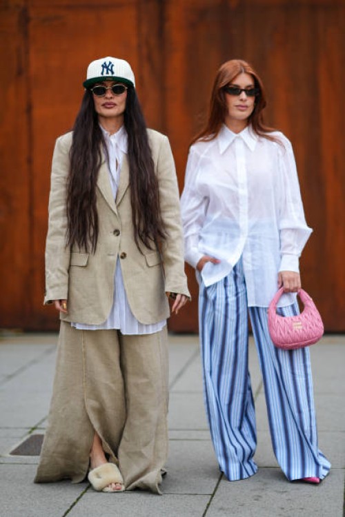 Angela Rozas Saiz wears a white cap, a white shirt, a beige oversized blazer jacket, matching pants, a beige fur sandals, sunglasses, Aida Domenech...