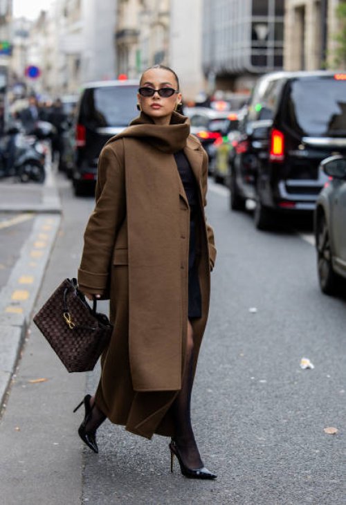 Anna Wein wears brown coat, bag, sunglasses outside Sacai during Womenswear Spring/Summer 2025 as part of Paris Fashion Week on September 30, 2024 in...
