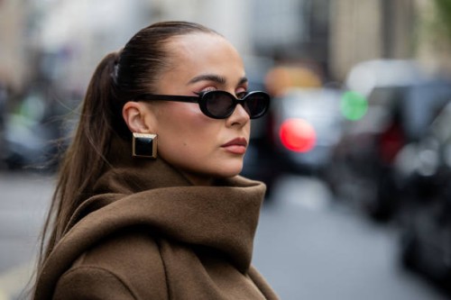 Anna Wein wears brown coat, earrings, sunglasses outside Sacai during Womenswear Spring/Summer 2025 as part of Paris Fashion Week on September 30,...
