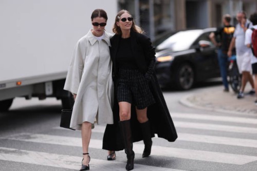 Annabel Rosendahl is seen wearing rectangular sunglasses with Havana frame, small silver hoop earrings, a fine silver necklace, a knee-length...