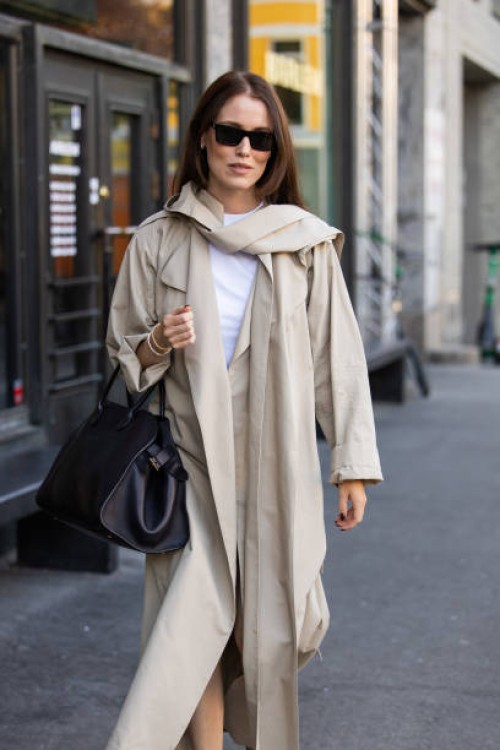 Annabel Rosendahl wears black bag, beige trench coat at Oslo Fashion Week 2024 on August 27, 2024 in Oslo, Norway.