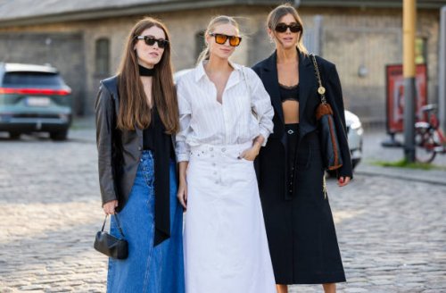 Annabel Rosendahl wears denim skirt, black blazer & Tine Andrea wears white striped button shirt skirt, bag & Darja Barannik wears Chanel bag, black...
