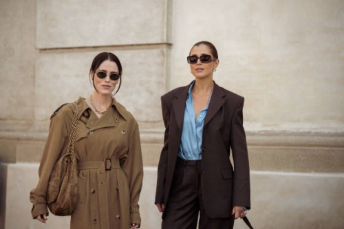 Annabel Rosendahl wears long beige or brown trench coat and brown bag and Darja Barannik wears brown pants, blue shirt and brown blazer and brown bag...