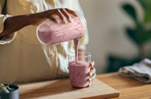 anonymous afro-american woman pouring a smoothie into a glass - food stock pictures, royalty-free photos & images