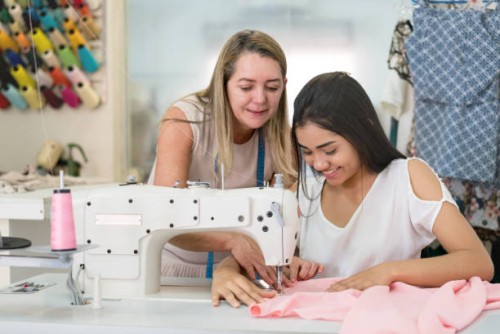 apprentice seamstress learning to sew at an atelier - fashion stock pictures, royalty-free photos & images
