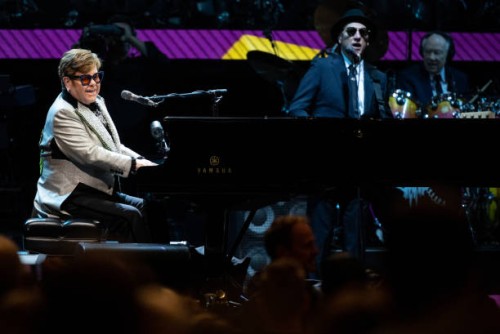 April 2023, Bavaria, Munich: Singer and pianist Elton John sits on stage at the Olympiahalle during a concert as part of his "Farewell Yellow Brick...