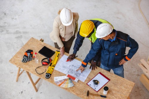 architect, business manager and civil engineer meeting project at planning desk - home decoration stockfoto's en -beelden