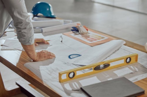 architect, hands and planning on blueprint for construction or preparation for building on office desk. hand of engineer in architectural design for project, floor plan or industrial layout strategy - home decoration stock pi