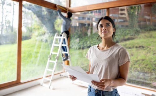 architect renovating a house and holding designs at the construction site - home decoration stock pictures, royalty-free photos & images