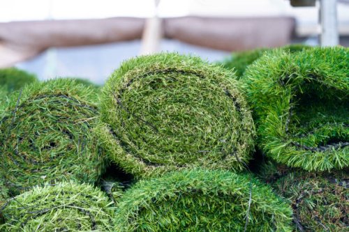 artificial synthetic grass rolled up in a store on display for sale - garden decoration stock pictures, royalty-free photos & images