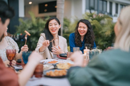 asian chinese lesbian couple and friends enjoying outdoor dining together - food stock pictures, royalty-free photos & images