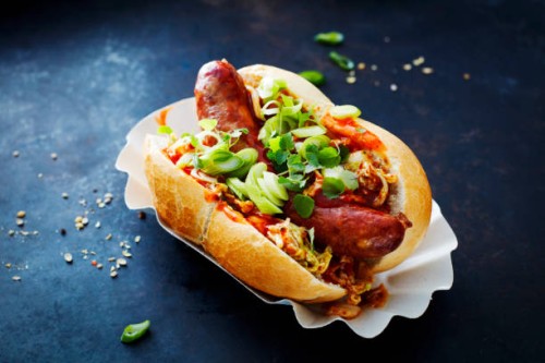 asian hot dog, fried sausage, spicy chinese cabbage, hot chili sauce, spring onions, cress, bun - junk food stock pictures, royalty-free photos & images