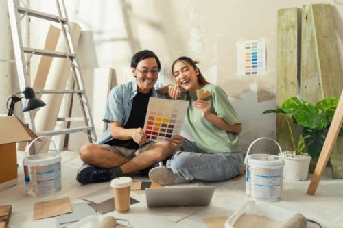 asian lover marry couple sit relax choosing new colour after test paint new colour new apartment home relocation moving in new house,asia husband wife sit using laptop searching ideas for home decorating sit on floor daytime 