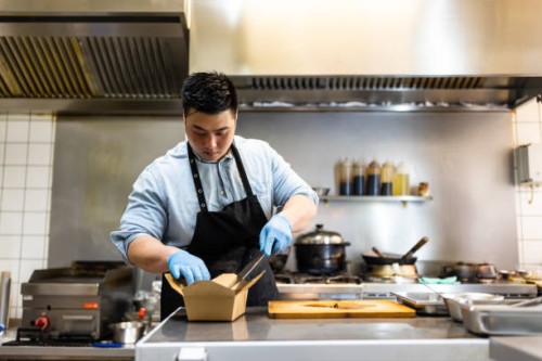 asian male cook making food parcel for delivery - junk food stock pictures, royalty-free photos & images