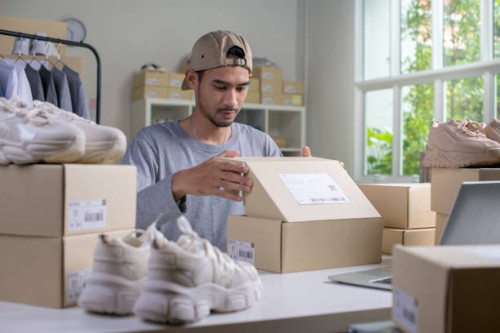 asian man business owner working, packing the order for shipping to customer. - fashion stock pictures, royalty-free photos & images