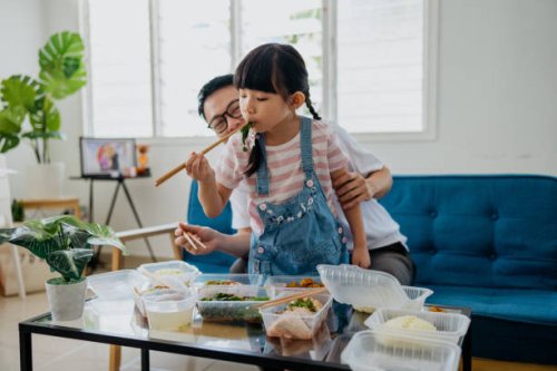 asian man having take out food with his daughter - junk food stock pictures, royalty-free photos & images