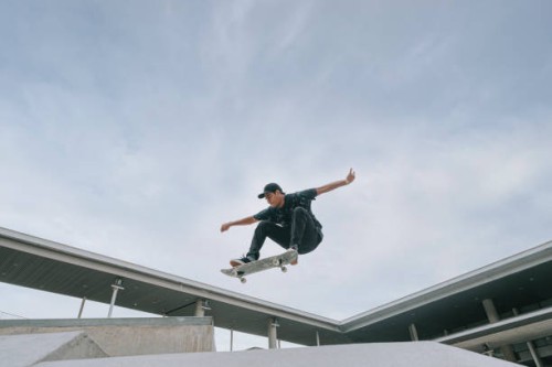 asian skateboarder in action mid air - fashion stock pictures, royalty-free photos & images
