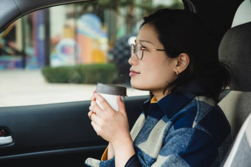 asian woman enjoying coffee in a reusable cup-1 - junk food stock pictures, royalty-free photos & images