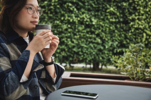 asian woman enjoying coffee using reusable cup - junk food stock pictures, royalty-free photos & images