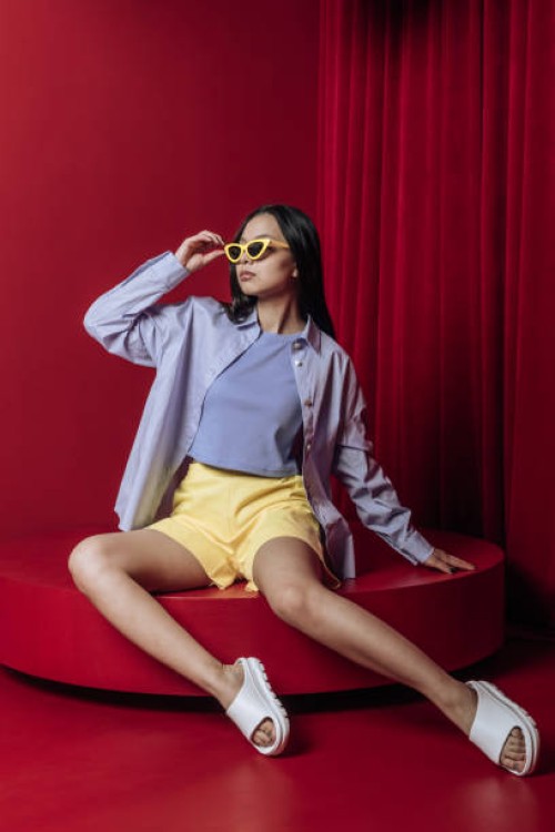 asian woman fashion sitting studio shot - fashion stock-fotos und bilder