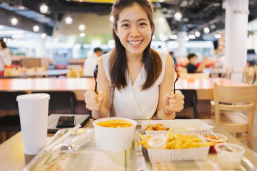 asian woman hand hold fork and spoon ready to enjoy fried chicken for eat korean food at airport - junk food stock pictures, royalty-free photos & images