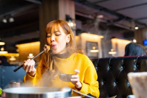 asian woman having lunch eating hot pot at restaurant - food stock pictures, royalty-free photos & images
