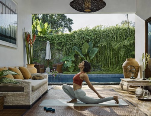 asian woman practicing yoga during home workout in open living room, in front of pool garden - garden decoration photos et images de collection