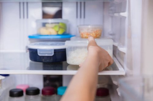 asian woman stored leftovers food in plastic container put into refrigerator. - food stock pictures, royalty-free photos & images