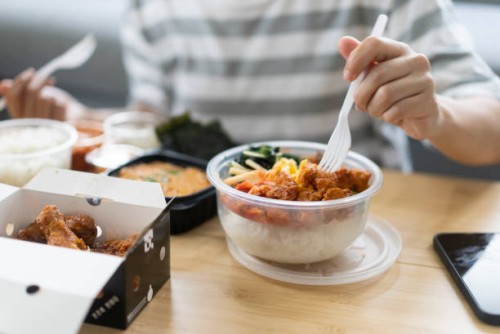 asian young adult order takeaway bibimbap and fried chicken korean style korean food and cuisine delivery food service for lunch at home - junk food stock pictures, royalty-free photos & images