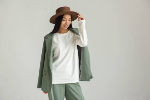 asian young model posing in beautiful brand clothes on a white background on a cyclorama - fashion stock pictures, royalty-free photos & images
