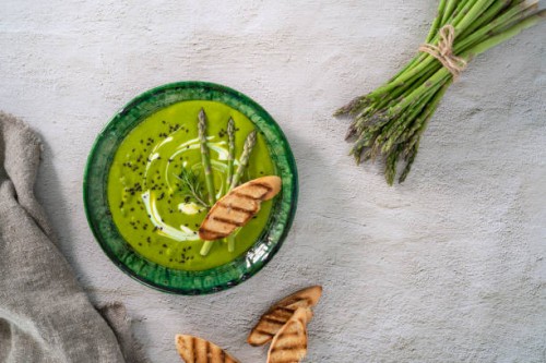 asparagus soup plate with ingredients and bread toasts on white cement - food stock pictures, royalty-free photos & images