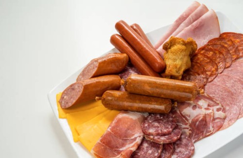 assorted cold cuts, sausages and cheese on plate - junk food stock pictures, royalty-free photos & images