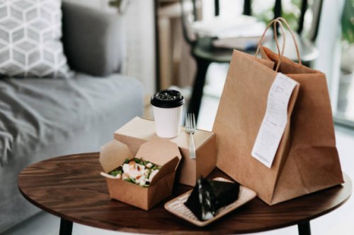 assorted fresh and healthy takeaway meals delivered at home, with healthy grilled chicken vegetable salad, japanese style rice ball / onigiri and a cup of coffee freshly served on the coffee table - junk food stock pictures, 