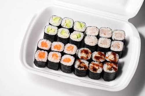 assorted sushi rolls in a takeaway box for delicious meal - junk food stock pictures, royalty-free photos & images