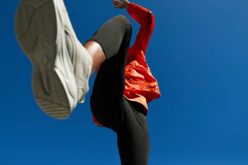 athlete running against clear blue sky on sunny day - fashion stock pictures, royalty-free photos & images